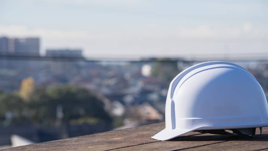 ヘルメットと街並み｜建設業・製造業イメージ